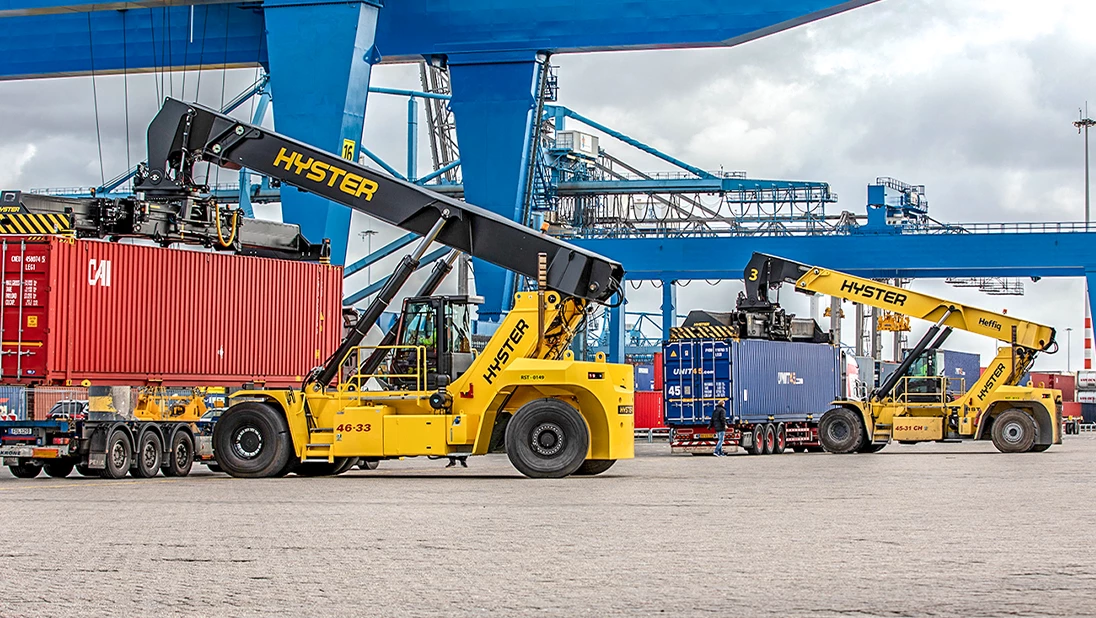 Hyster ReachStackers working moving containers in a port. 